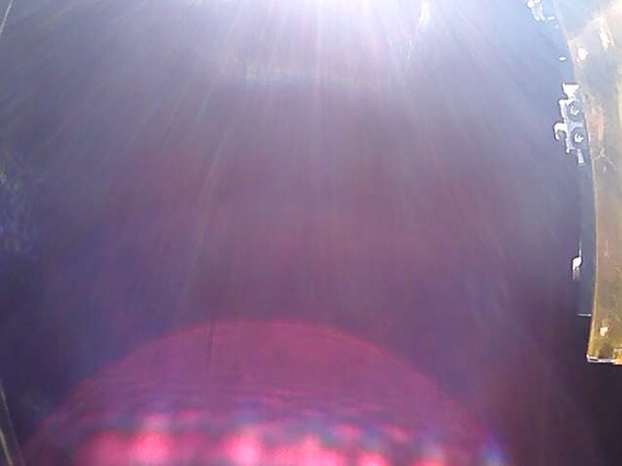 A picture of space from CatSat showing the edge of the deployed IADS door